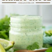 cilantro and garlic sauce in mason jar with spoon in front