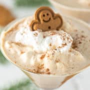 close-up of gingerbread martini with whipped cream and gingerbread man on top