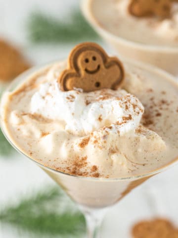 close-up of gingerbread martini with whipped cream and gingerbread man on top