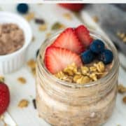 fruit and granola on top of some protein overnight oats in glass jar