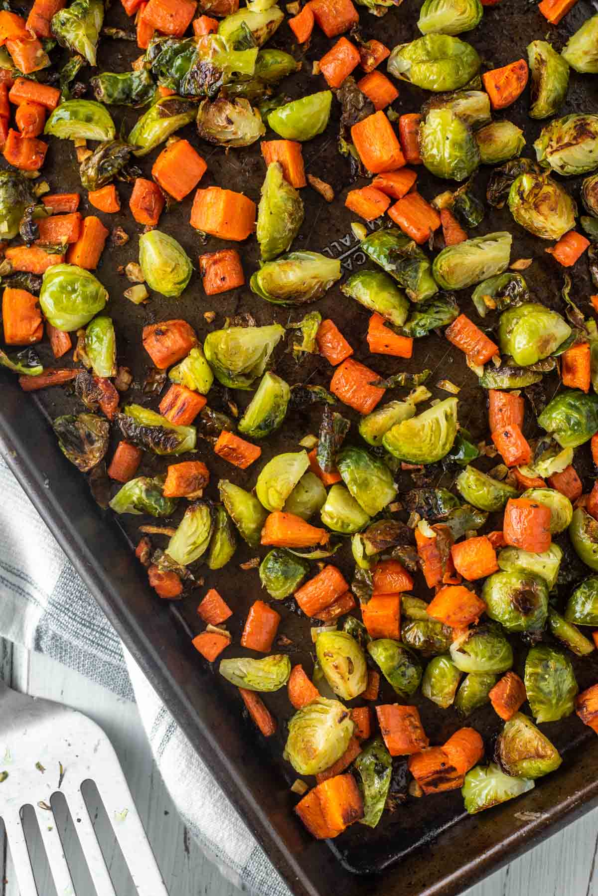 overhead shot of roasted Brussels sprouts and carrots in pan