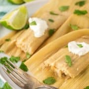 Instant Pot tamale cut in half with fork on plate