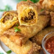 taco egg roll cut in half on top of other egg rolls