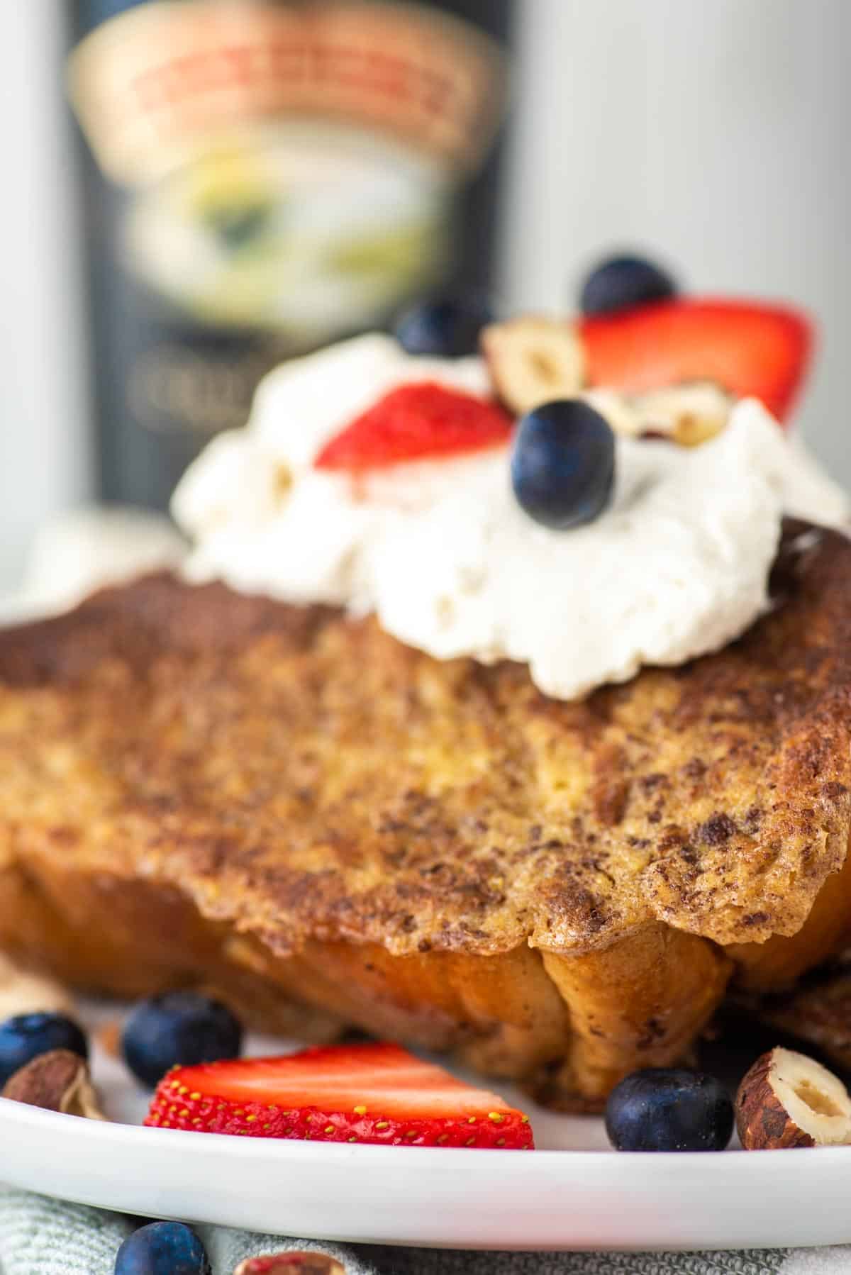 French toast with Baileys whipped cream on white plate