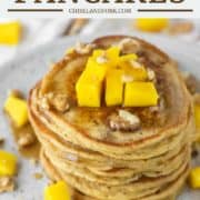 a stack of mango pancakes on plate with fork