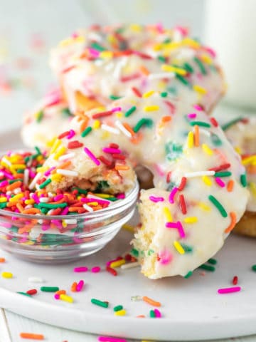 funfetti donut dipped in bowl of sprinkles