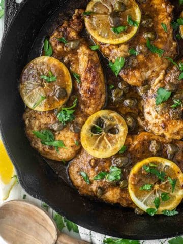 overhead shot of chicken piccata in cast iron skillet