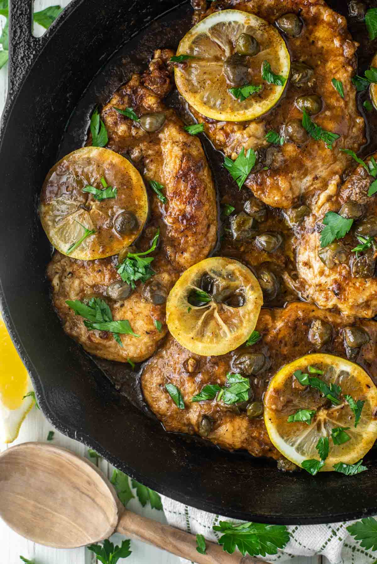overhead shot of chicken piccata in cast iron skillet