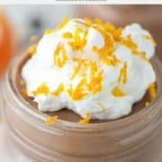 close-up of a glass of chocolate orange mousse with whipped cream on top