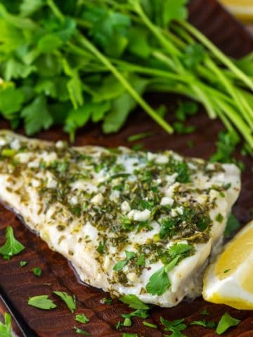 close-up of grilled haddock topped with lemon and herb sauce