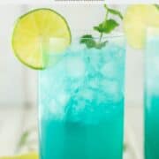 blue mojito in tall glass with lime and mint