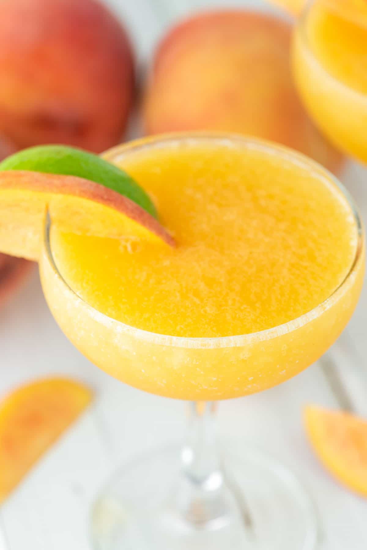 close-up of peach daiquiri in coupe glass