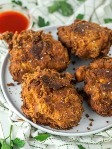 4 pieces of fried chicken thighs on plate