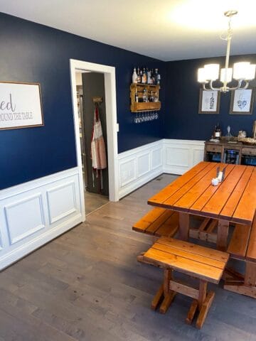 dining room wainscoting painted white with blue walls and table in the middle