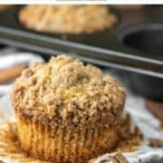 cinnamon streusel muffin with cupcake liner removed and more in background