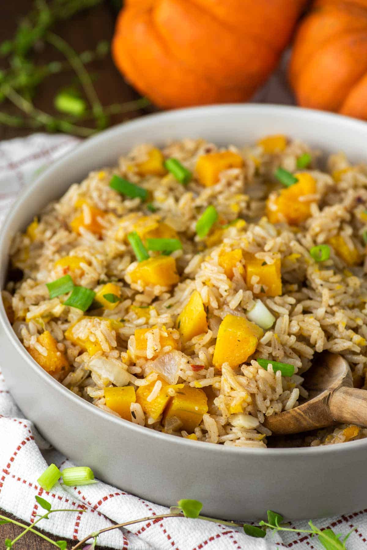 wooden spoon dipped in bowl of pumpkin rice