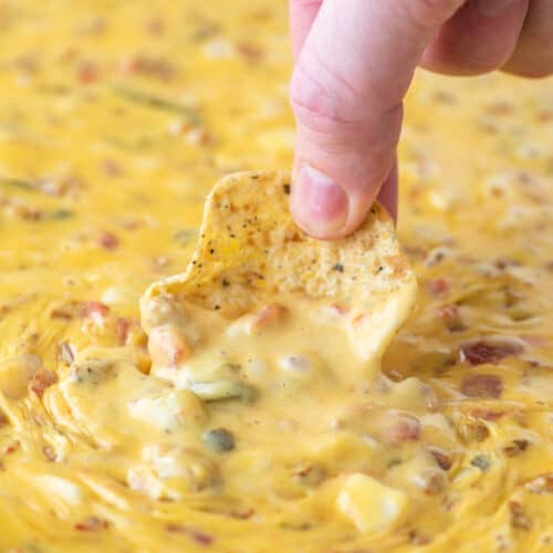 dipping chip in smoked queso