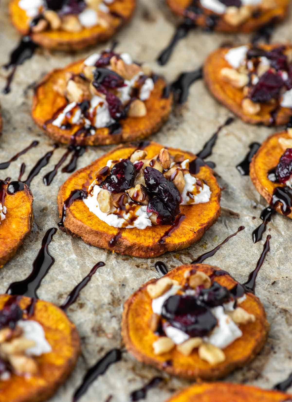 close-up of sweet potato rounds with goat cheese, walnuts, cranberries and balsamic vinegar
