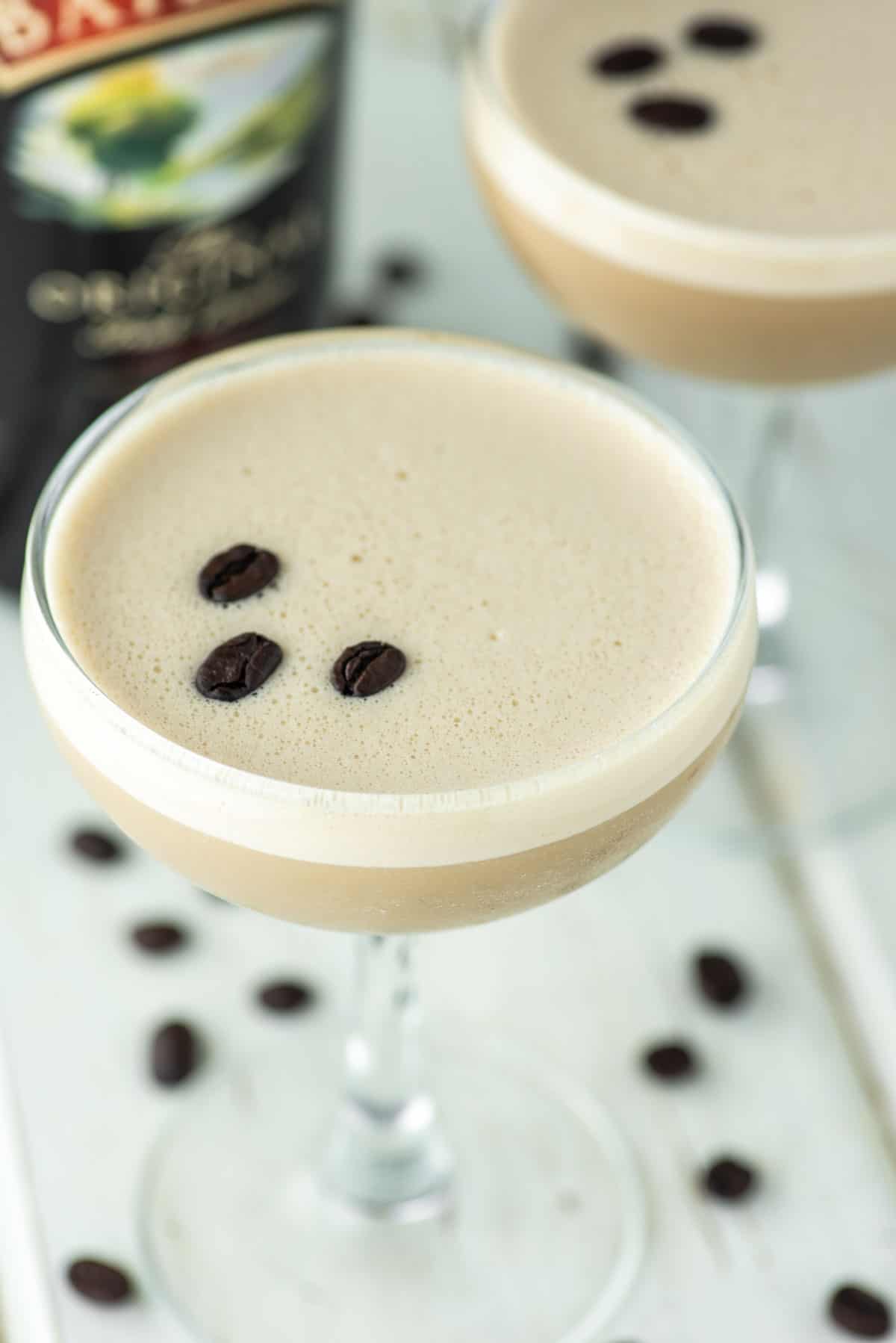 close-up of Baileys espresso martini in coupe glass with another in the background