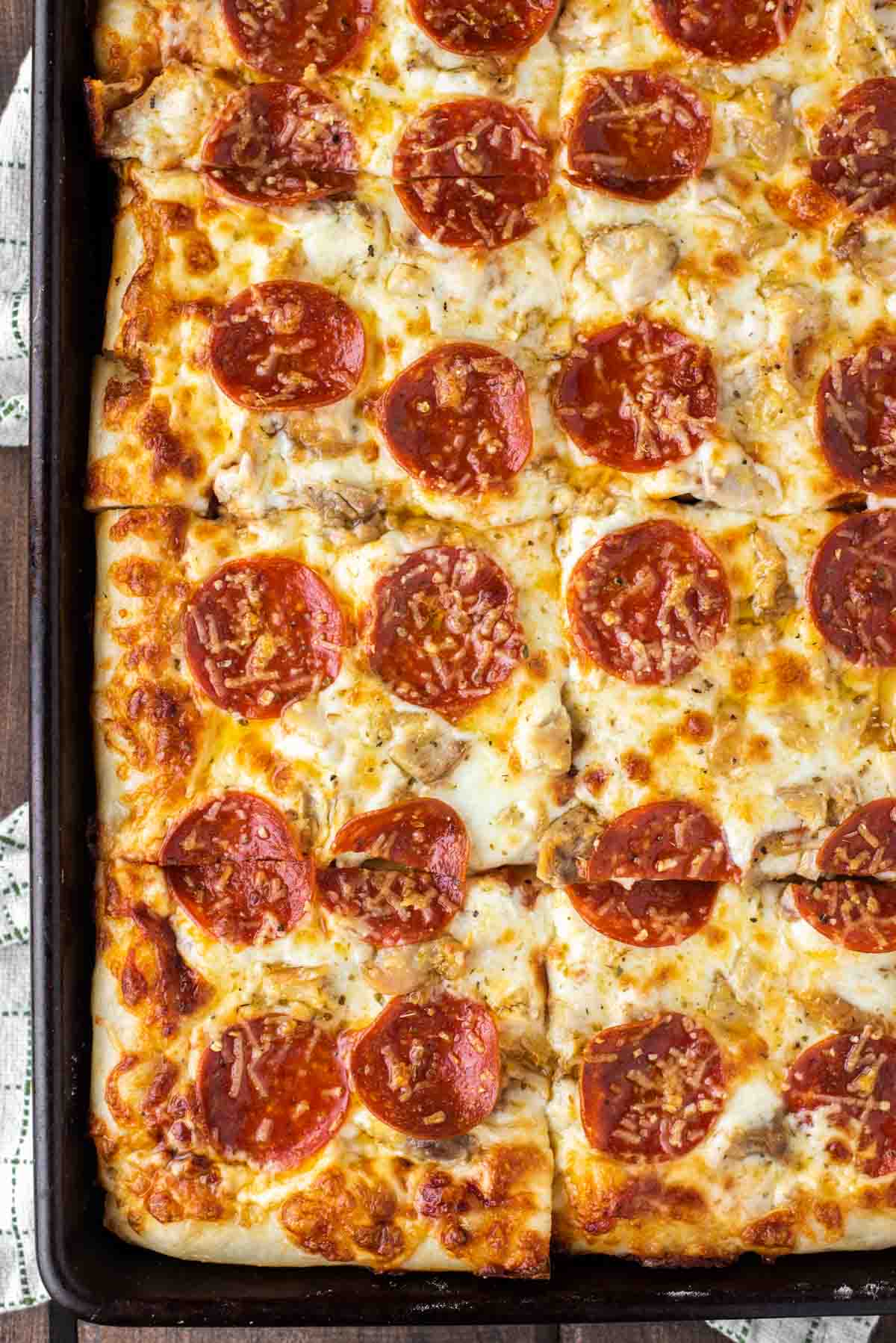 overhead shot of chicken pepperoni pizza on sheet pan