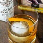 chocolate old fashioned in glass with large ice ball