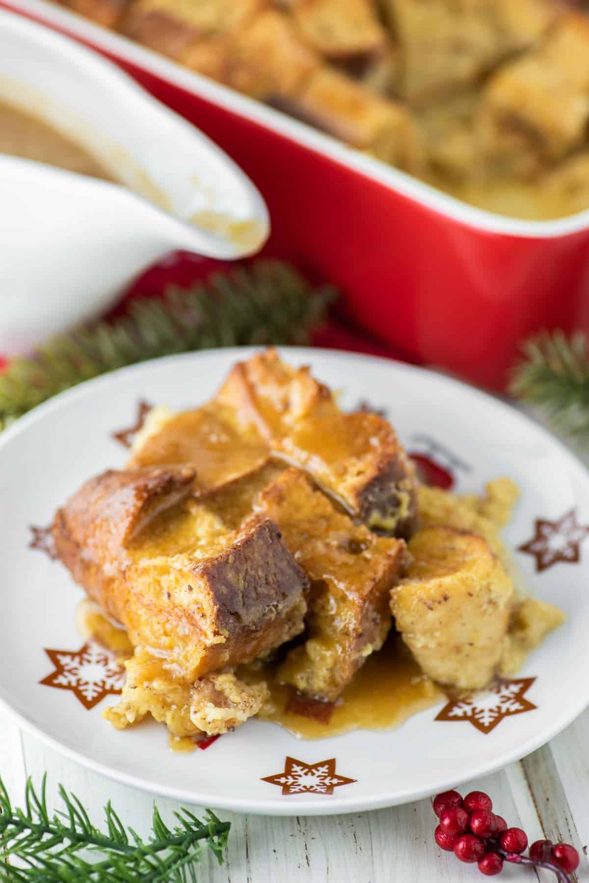 close-up of eggnog bread pudding on white plate with stars