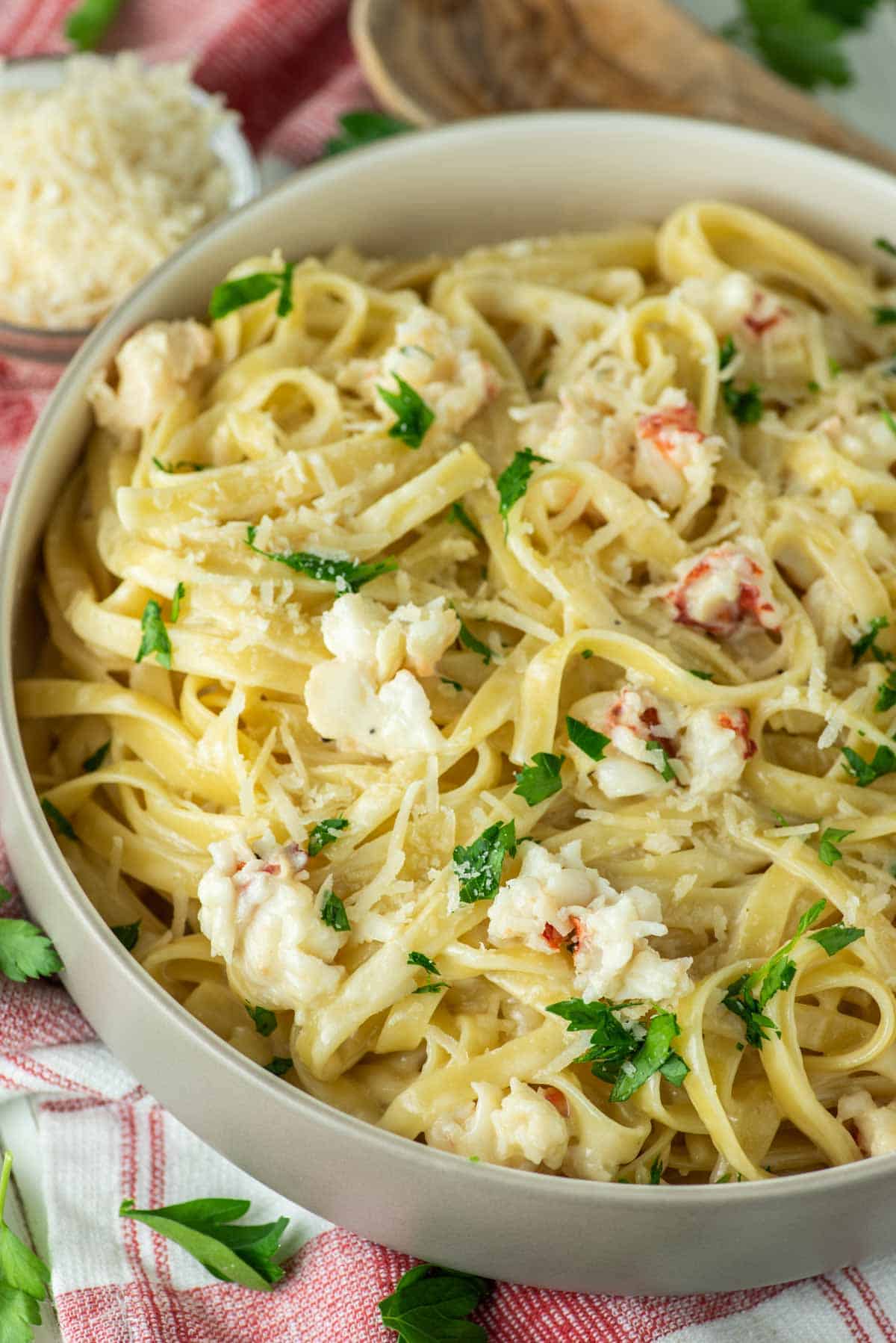 close-up of lobster alfredo in grey bowl