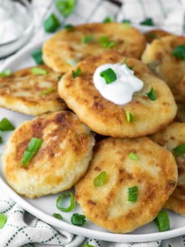 close-up of stacked mashed potato fritters on plate