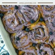 overhead shot of blueberry cinnamon rolls in white baking dish