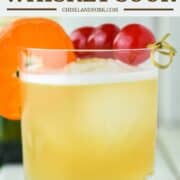 old fashioned glass of Jameson whiskey sour with cherries and orange slice as garnish
