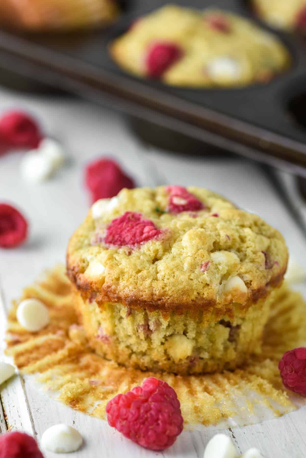 close-up of raspberry and white chocolate muffin on white board