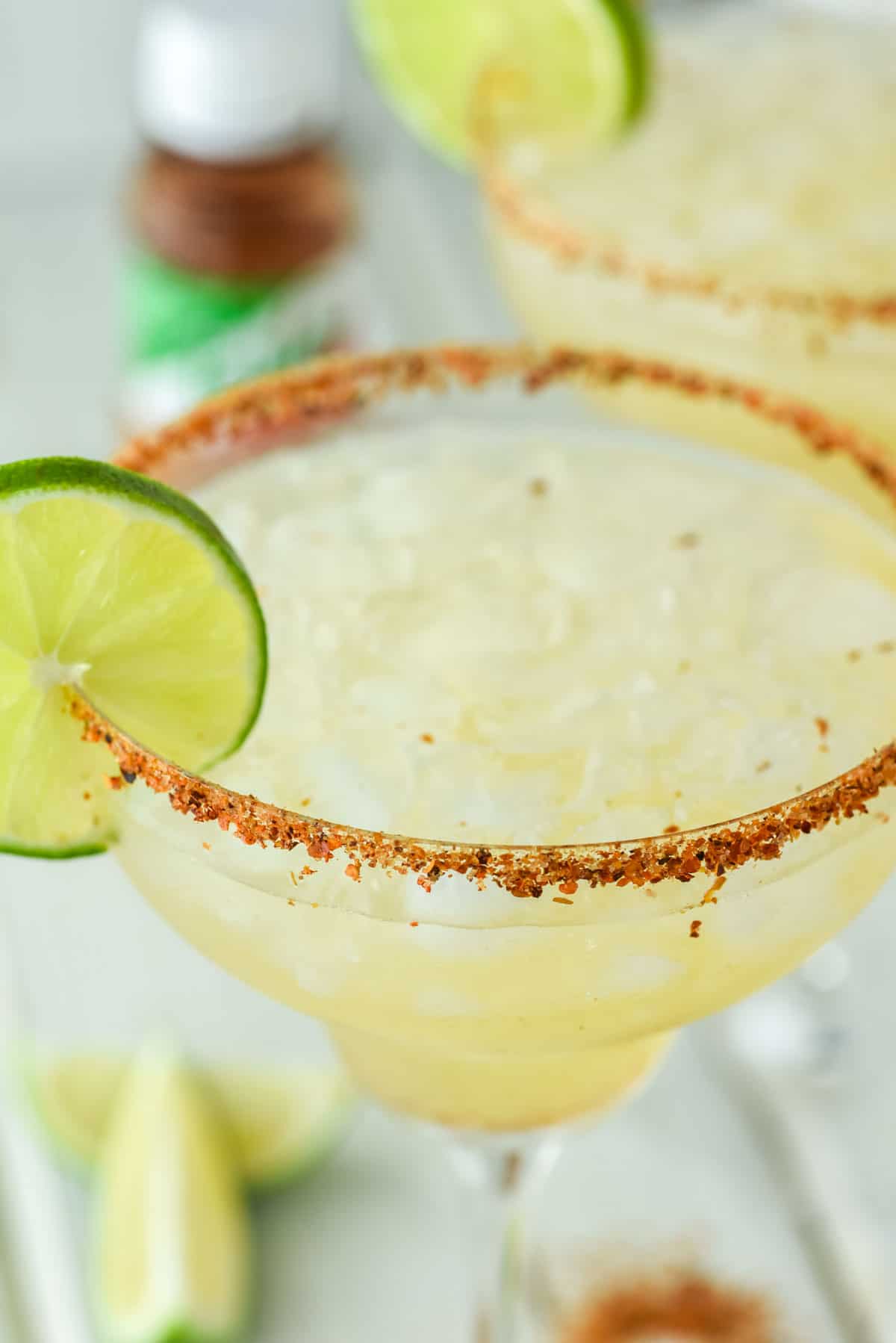 close-up of glass of tajin margarita with another in the background