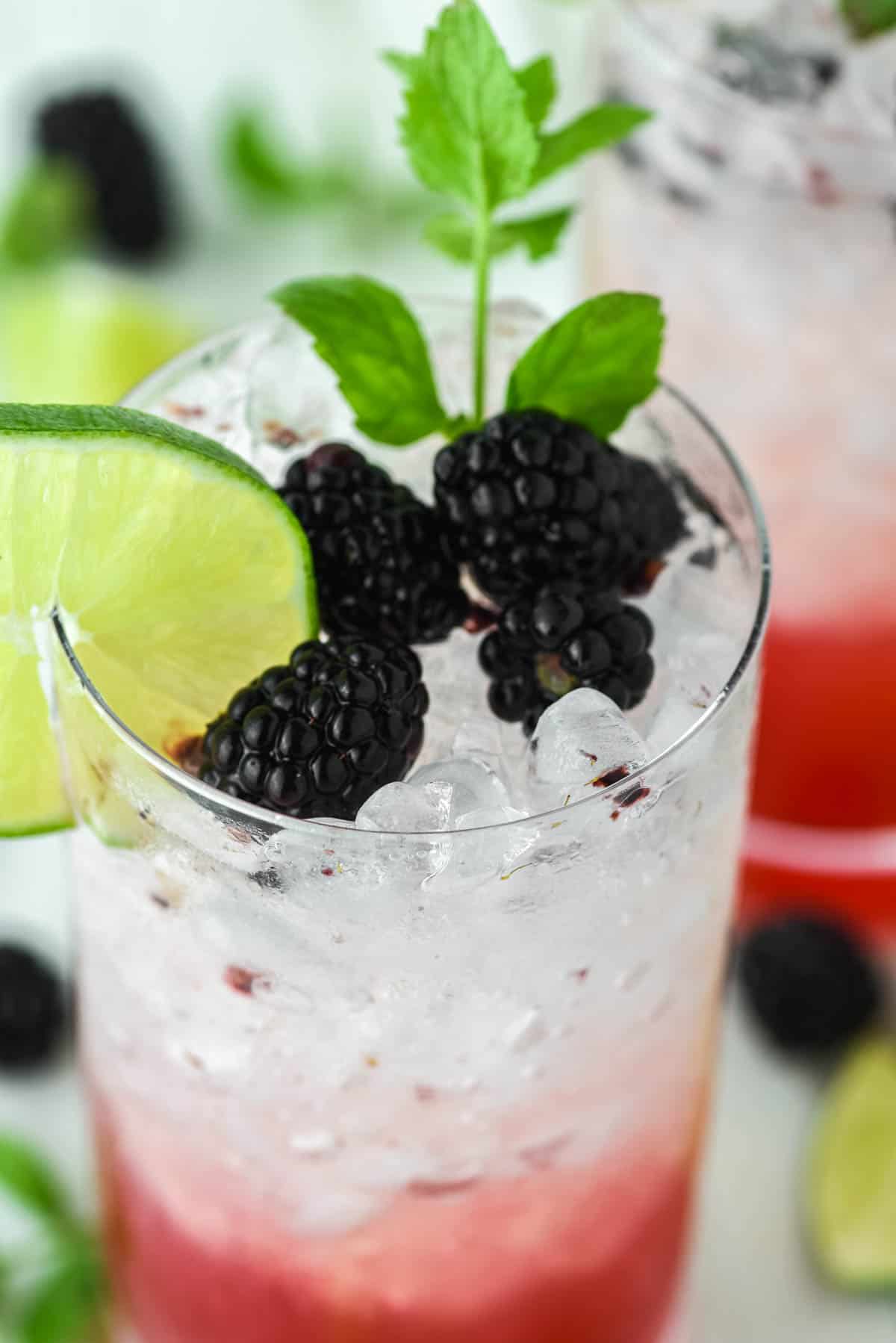 close-up of blackberry mojito in tall glass