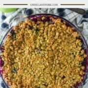 overhead shot of apple and blueberry crumble in glass pie dish