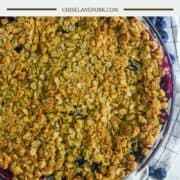 overhead shot of glass pie dish filled with apples and blueberries and a crumble topping