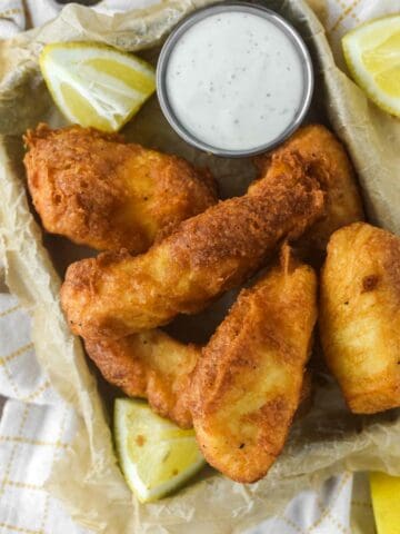 overhead shot of parchment-lined tin filled with beer battered halibut