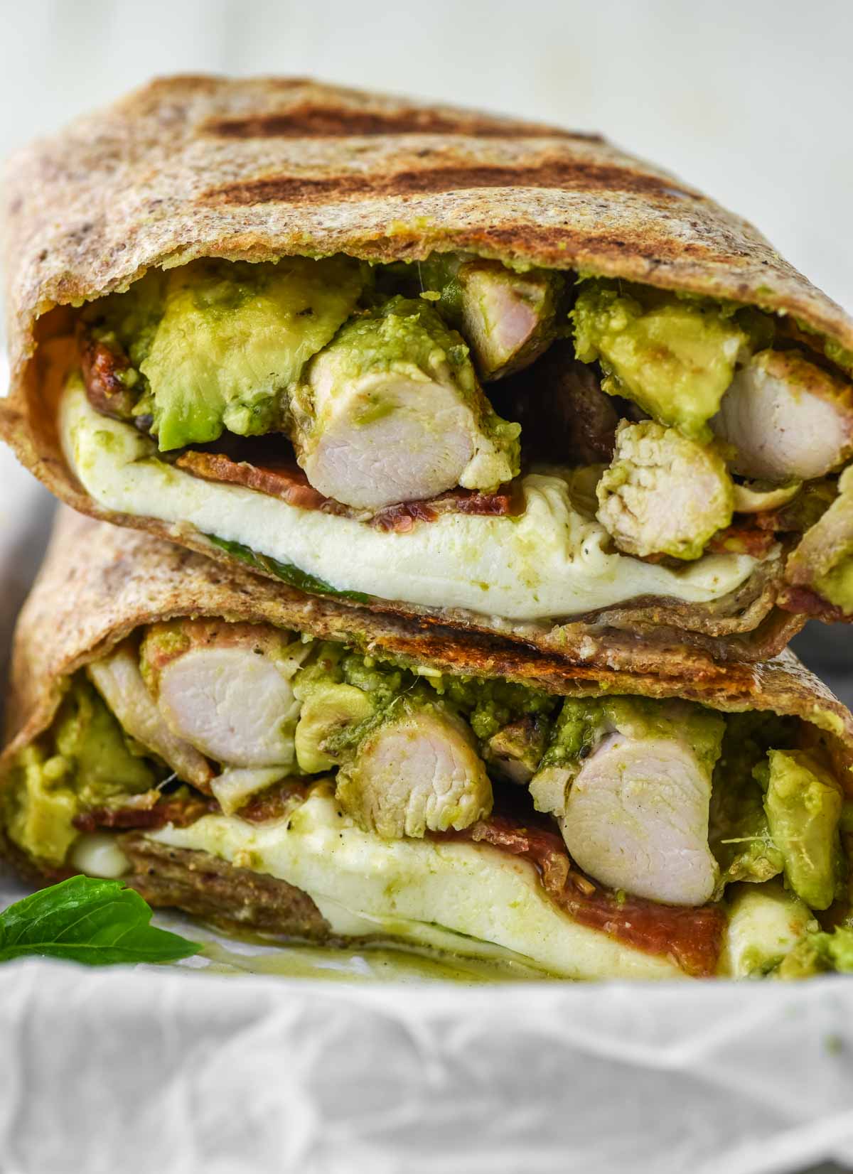 close-up of chicken pesto wrap stacked on top of each other