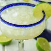 close-up of rum margarita in margarita glass with lime