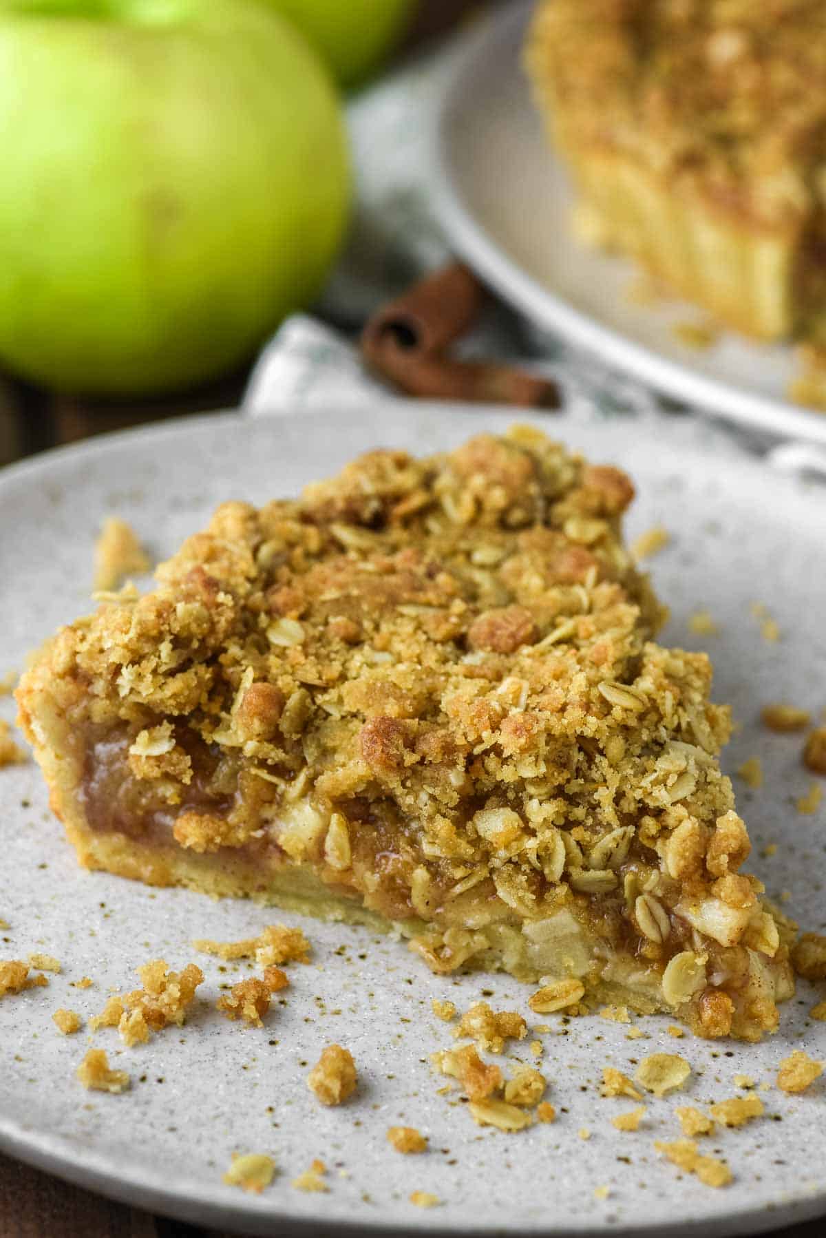 slice of apple crumble tart on speckled plate