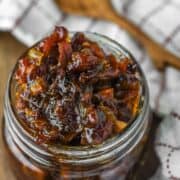 bacon jam in glass jar with spoon in background