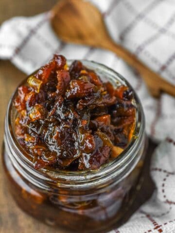 bacon jam in glass jar with spoon in background