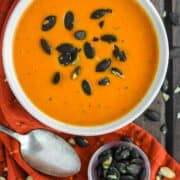 overhead shot of butternut squash and roasted red pepper soup in bowl