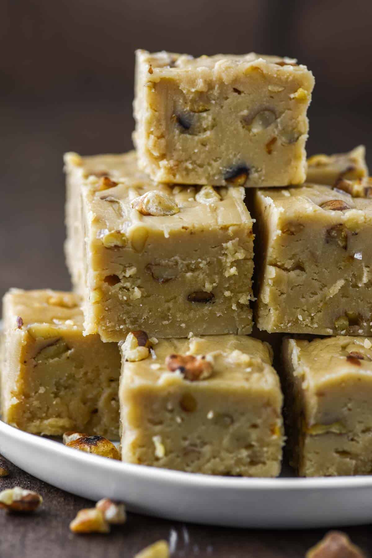 close-up of stacked maple walnut fudge on plate