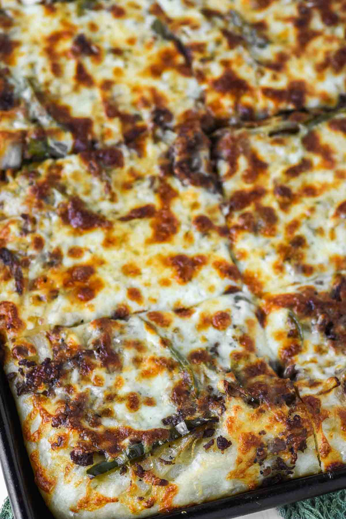 close-up of Philly cheesesteak pizza in pan