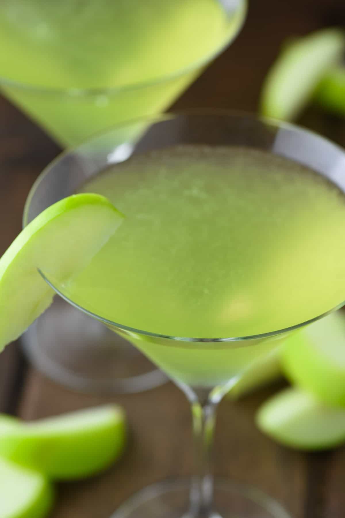close-up of sour apple martini in v shaped glass