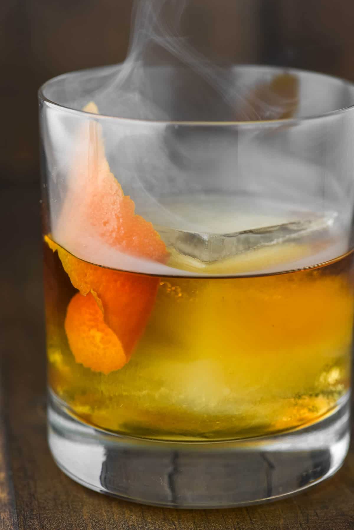 close-up of a glass of smoked old fashioned
