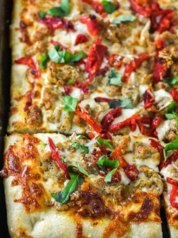 close-up of chicken sausage pizza on baking sheet