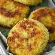 close-up of risotto cakes in parchment-lined metal tin
