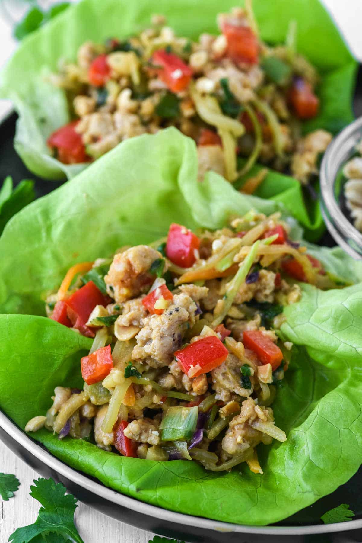 close-up of Thai chicken lettuce wraps on black plate