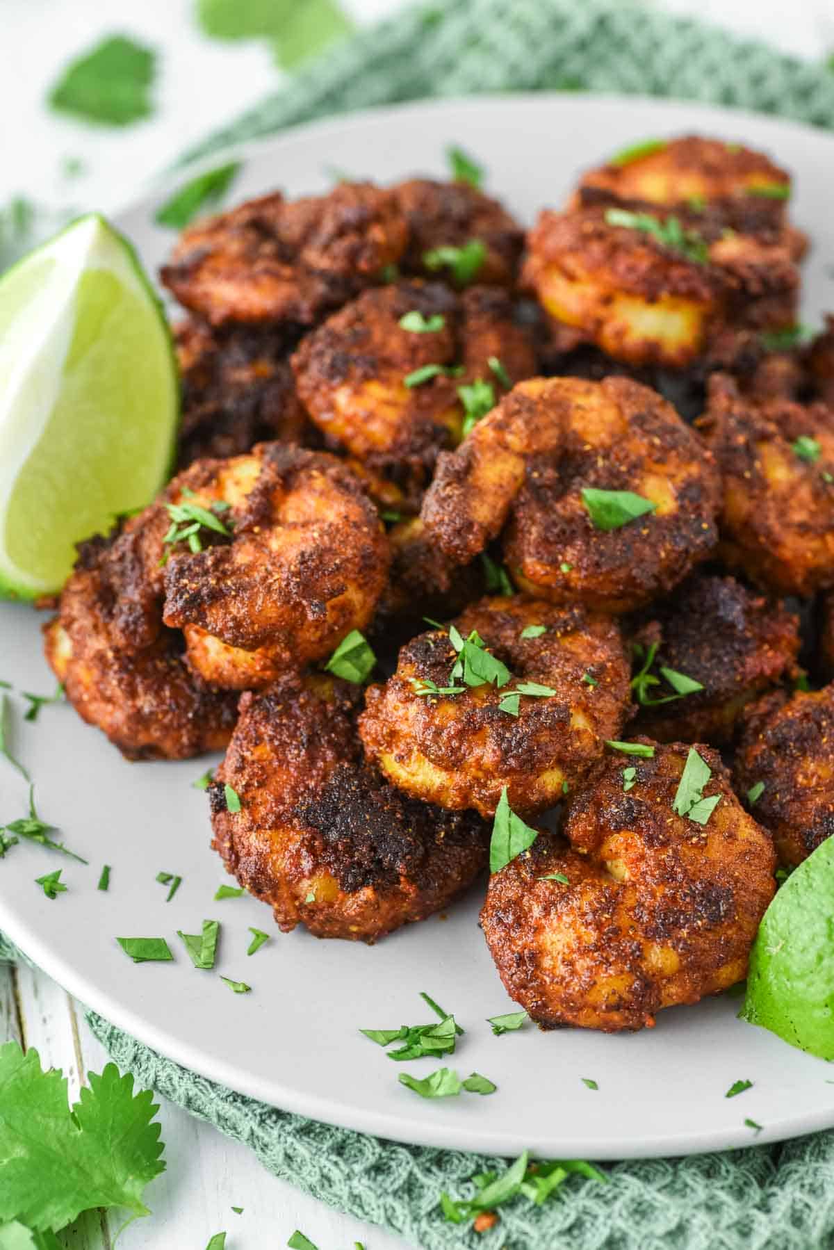 close-up of Tandoori shrimp on plate with limes